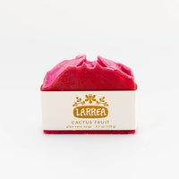 Red soap bar with 'Larrea' branding on a white background