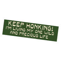 Green bumper sticker with white text on a white background