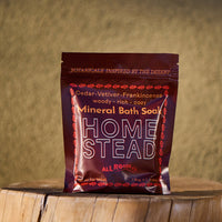 Home Stead Mineral Bath Soap package on a wooden surface with a blurred natural background