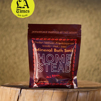 Mineral bath soap package on a wooden surface with 'LA Times' gift guide badge.