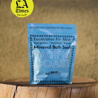 Blue package of Pacific Coast Mineral Bath Soap on a wooden surface with 'LA Times' gift guide badge.