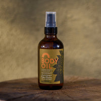 Body oil bottle with a label on a wooden surface and textured background