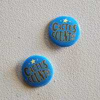Two blue buttons with 'Cactus Country' text on a light gray background
