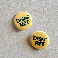 Two yellow buttons with 'Desert Rat' text on a gray background