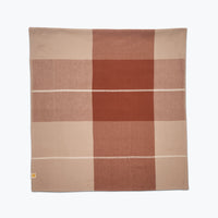Checkered tablecloth with brown and beige squares on a white background