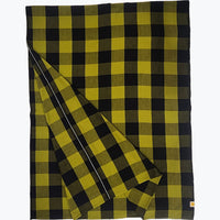 A folded plaid blanket or throw in a yellow and black buffalo check pattern, displayed on a clean white background.