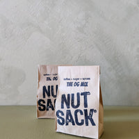 Two 'Nut Sack' packages on a textured surface with a neutral background
