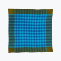 Bright sky blue and olive green plaid cloth napkin.