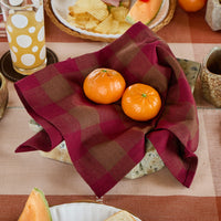 Plated food with oranges on a checkered tablecloth
