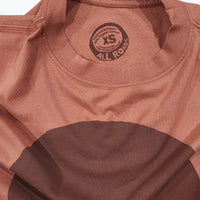 Brown shirt with a logo on the chest area against a white background