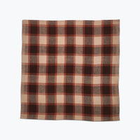 Plaid fabric with brown and beige pattern on a white background
