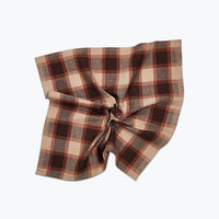 Plaid fabric with a brown and beige pattern on a white background