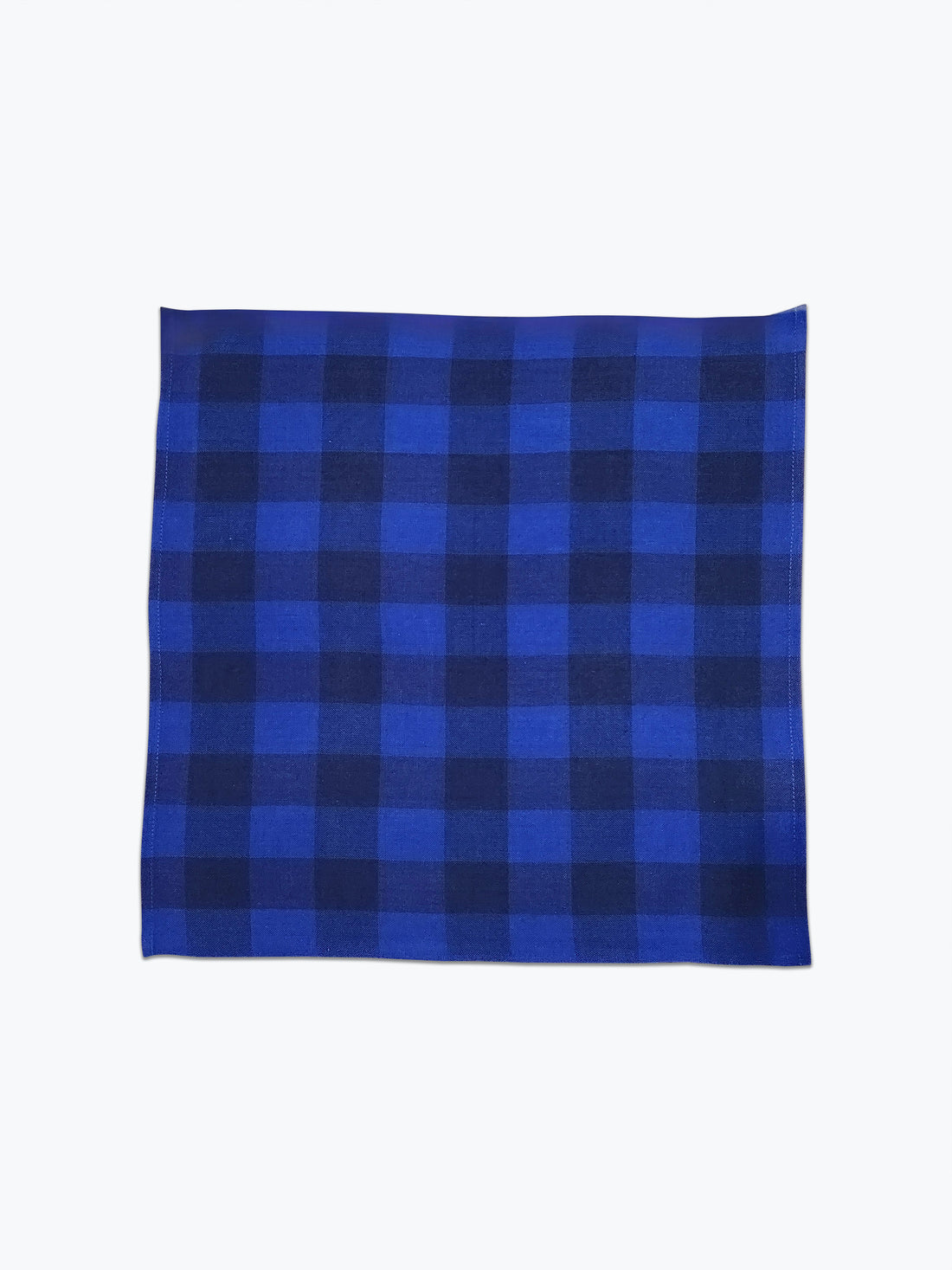 Large scale gingham plaid cotton napkin in 2 tonal blue colors.