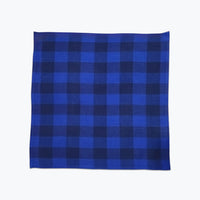 Large scale gingham plaid cotton napkin in 2 tonal blue colors.