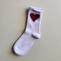 Beige cashmere women's crew sock with a dark red heart on the side.
