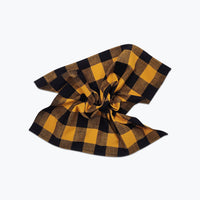 Large scale gingham plaid napkin in ochre yellow and black.