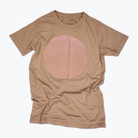 Tan t-shirt with a large, subtle faded pale pink circle printed on the front.