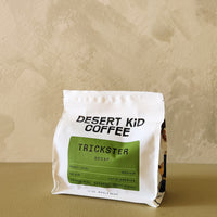 Desert Kid Coffee Trickster Decaf package on a beige background