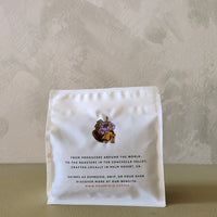 White coffee package with a logo on a beige background