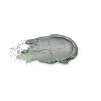 A thick, textured smear of sage green cosmetic cream or clay mask on a solid white background, with fine particles visibly splashing from the left side.