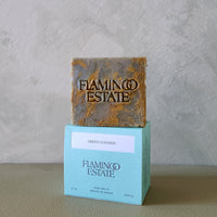 Bar of soap with 'Flamingo Estate' branding on a gray background
