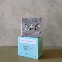 Bar of soap on a box with 'Flamingo Estate' branding against a neutral background