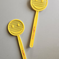 Yellow smiley face fly swatter.
