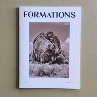 Book titled 'Formations' with a cover featuring a black and white photograph of large boulders on a beige wall.