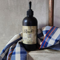A 16oz black bottle of liquid soap scented with cedar, vetiver and frankinscense essential oils.