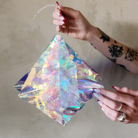 Fold out iridescent star with hanging loop.
