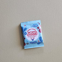 Jom gummy package on a plain background