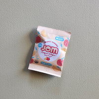 Jom snack package on a gray background