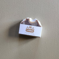 Bar of soap with a label on a gray background