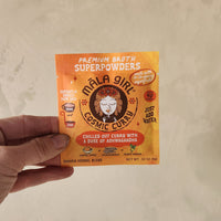 A single serve packet of mushroom based curry broth.