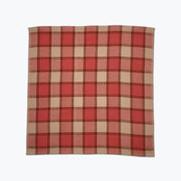 Red and beige plaid fabric on a white background