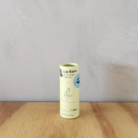 A vegan lip balm flavored with sweet orange tangerine in a cardboard tube.