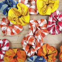 Cheerful scrunchies in a variety of primary color plaid and stripes.