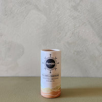 Cylindrical product packaging with 'humble' branding on a neutral background