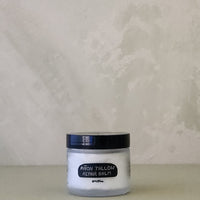 Jar of repair balm on a neutral background