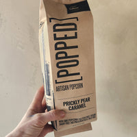 a bag of popcorn coated in prickly pear caramel.