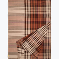 Plaid blanket with brown and beige colors on a white background