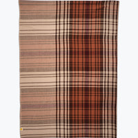Plaid blanket with brown, beige, and red colors on a white background