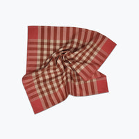 Pink and beige checkered fabric folded on a white background