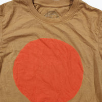 Ochre t-shirt with a large orange circle on a beige background