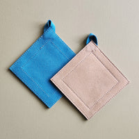 Teal and tan suede leather square potholder.