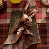 Plaid cloth on a ceramic tray with a checkered tablecloth background
