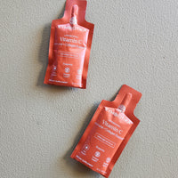 Two red packets of Symprove Vitamin C Collagen Peptide on a gray background