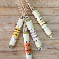 Bundles of copal incense sticks, wrapped in metallic and colored papers.