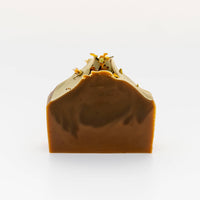 Bar of soap with a textured top on a white background