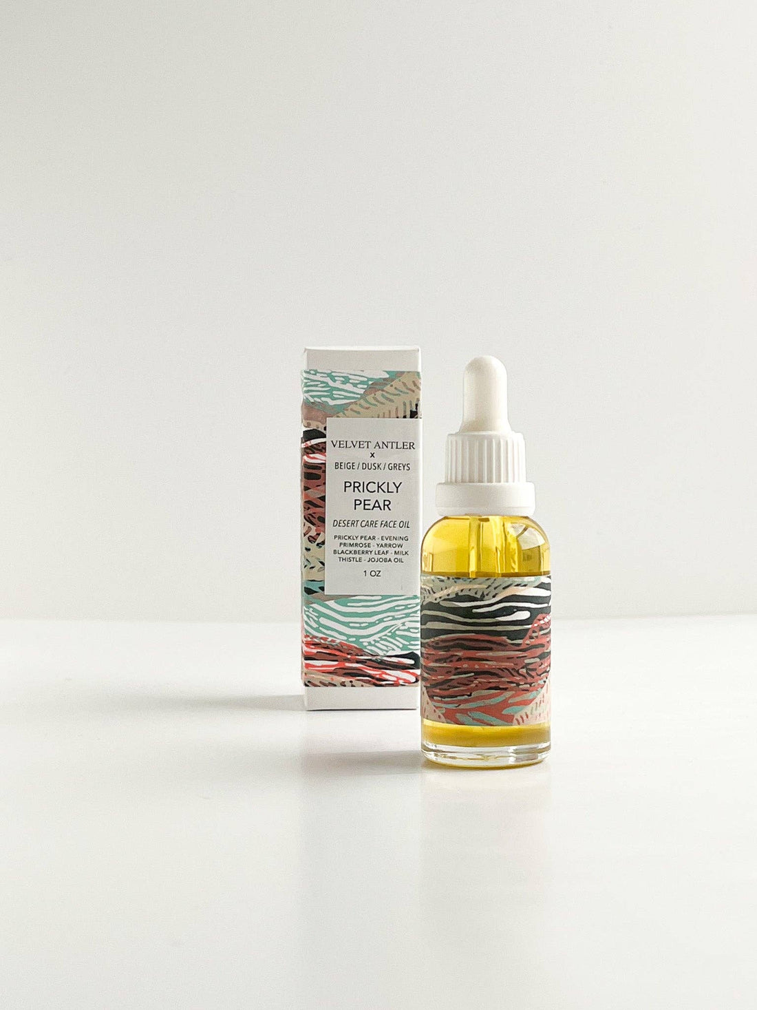 Bottle of Prickly Pear skincare product with packaging on a white background
